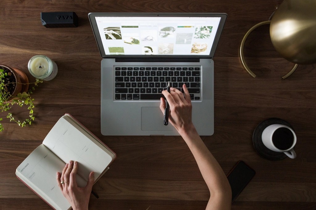 Women working on computer at her desk.